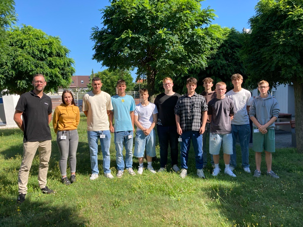 Group photo of the new apprentices with their vocational trainer