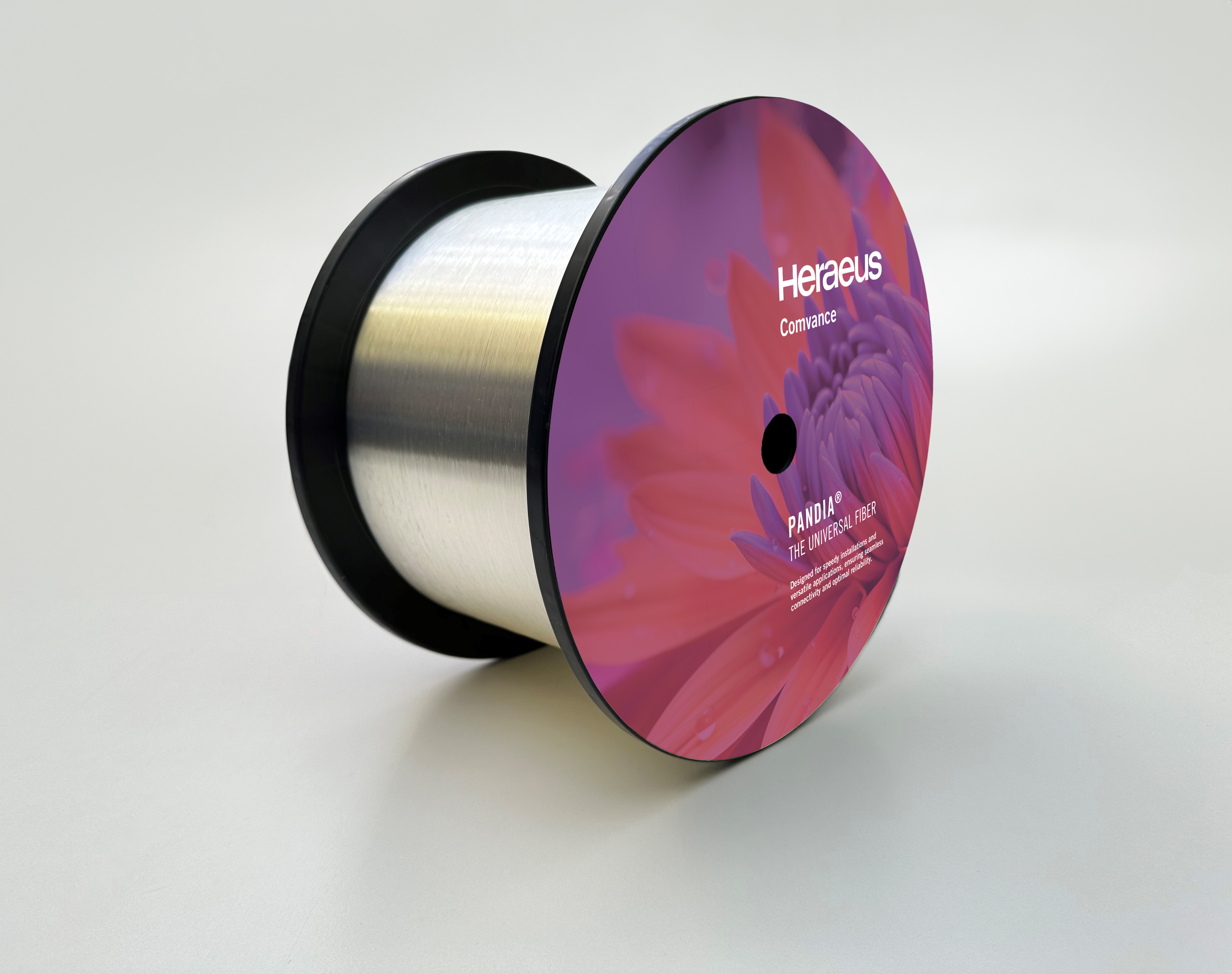 Product image of a fiber optic spool with pink label on a white background