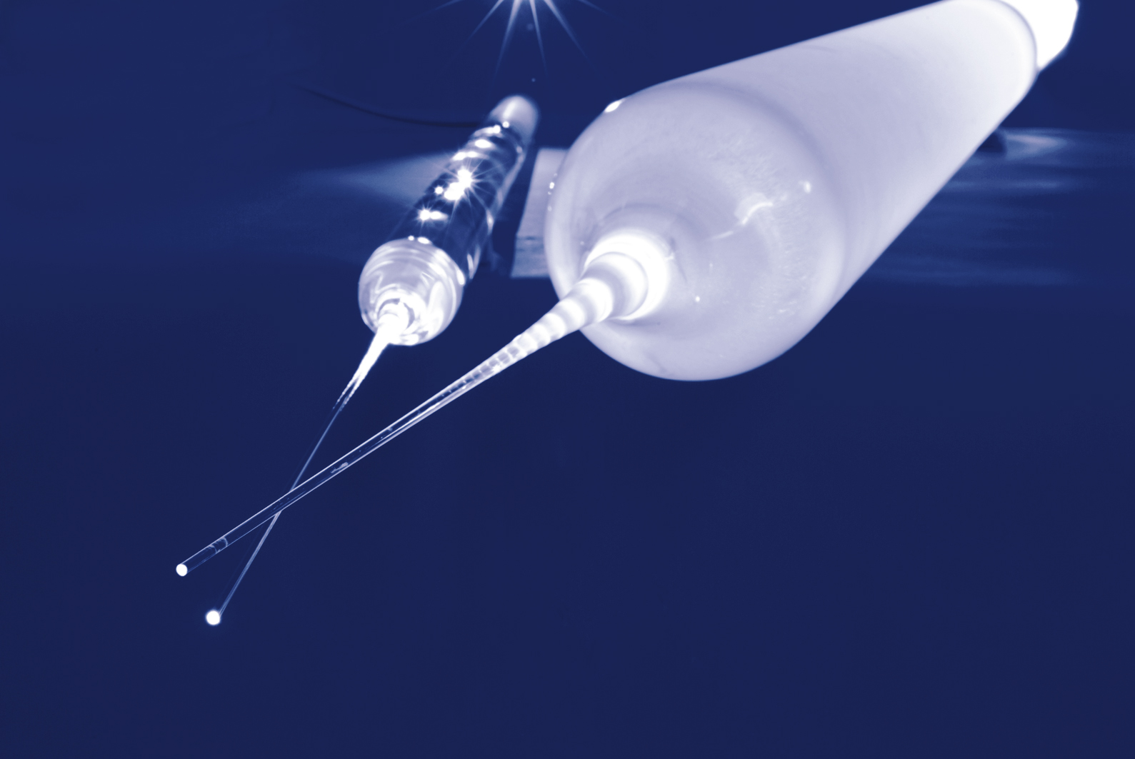 Two preforms with tip graphically staged on a blue background