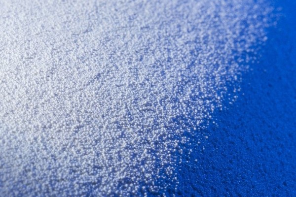 white granulate, illuminated in blue