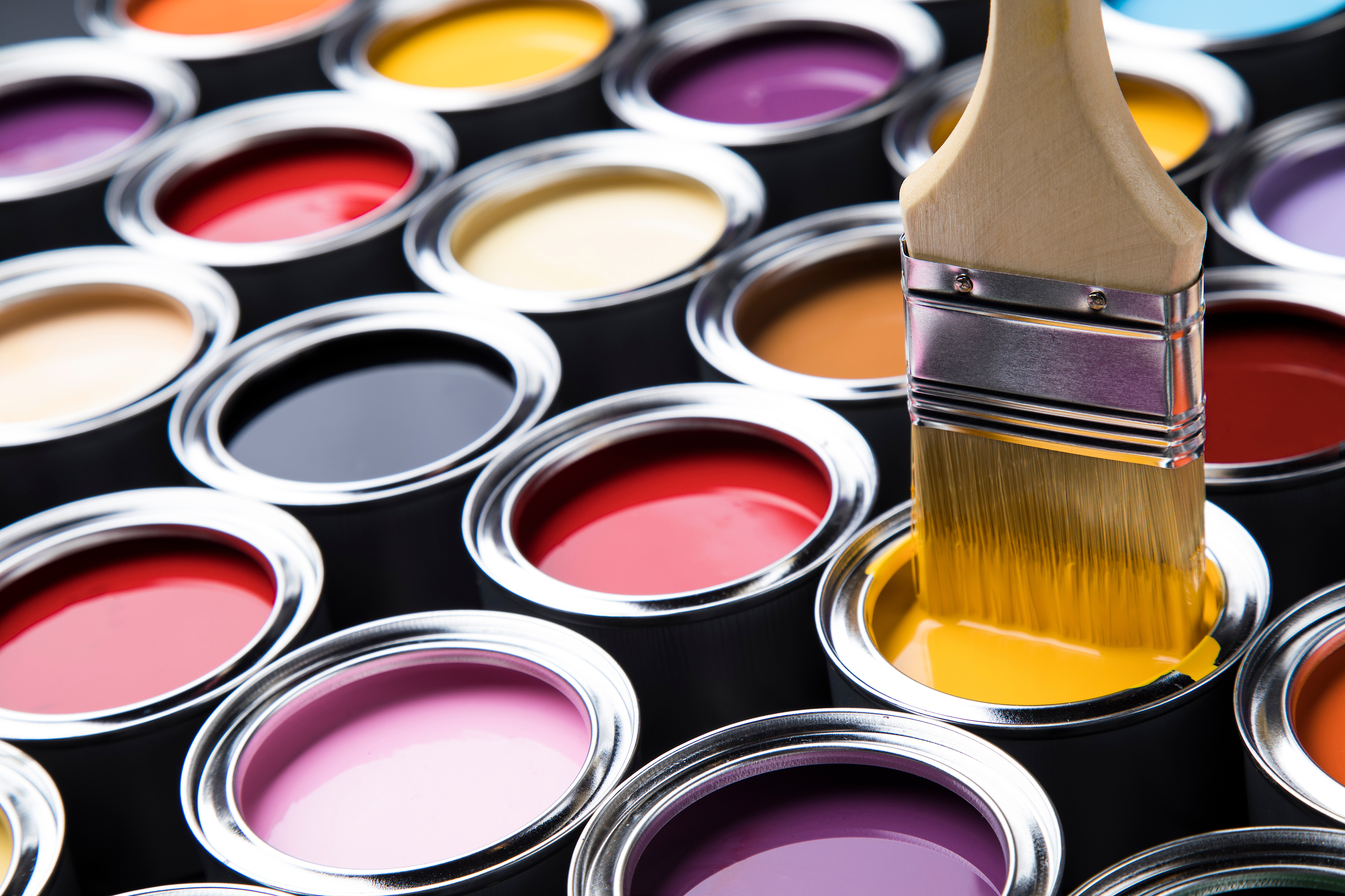 Metal tin cans with color paint and paintbrush