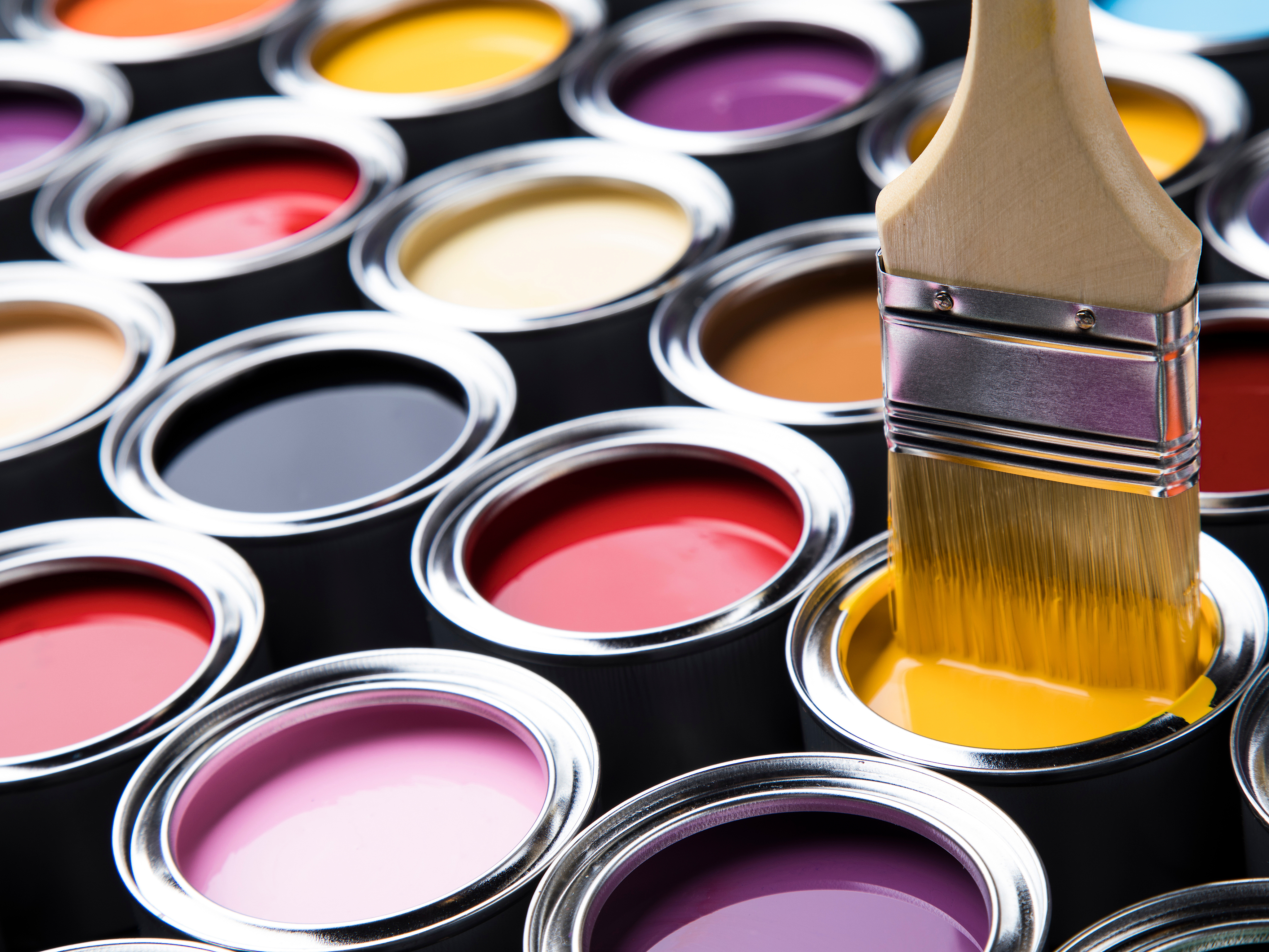 Metal tin cans with color paint and paintbrush