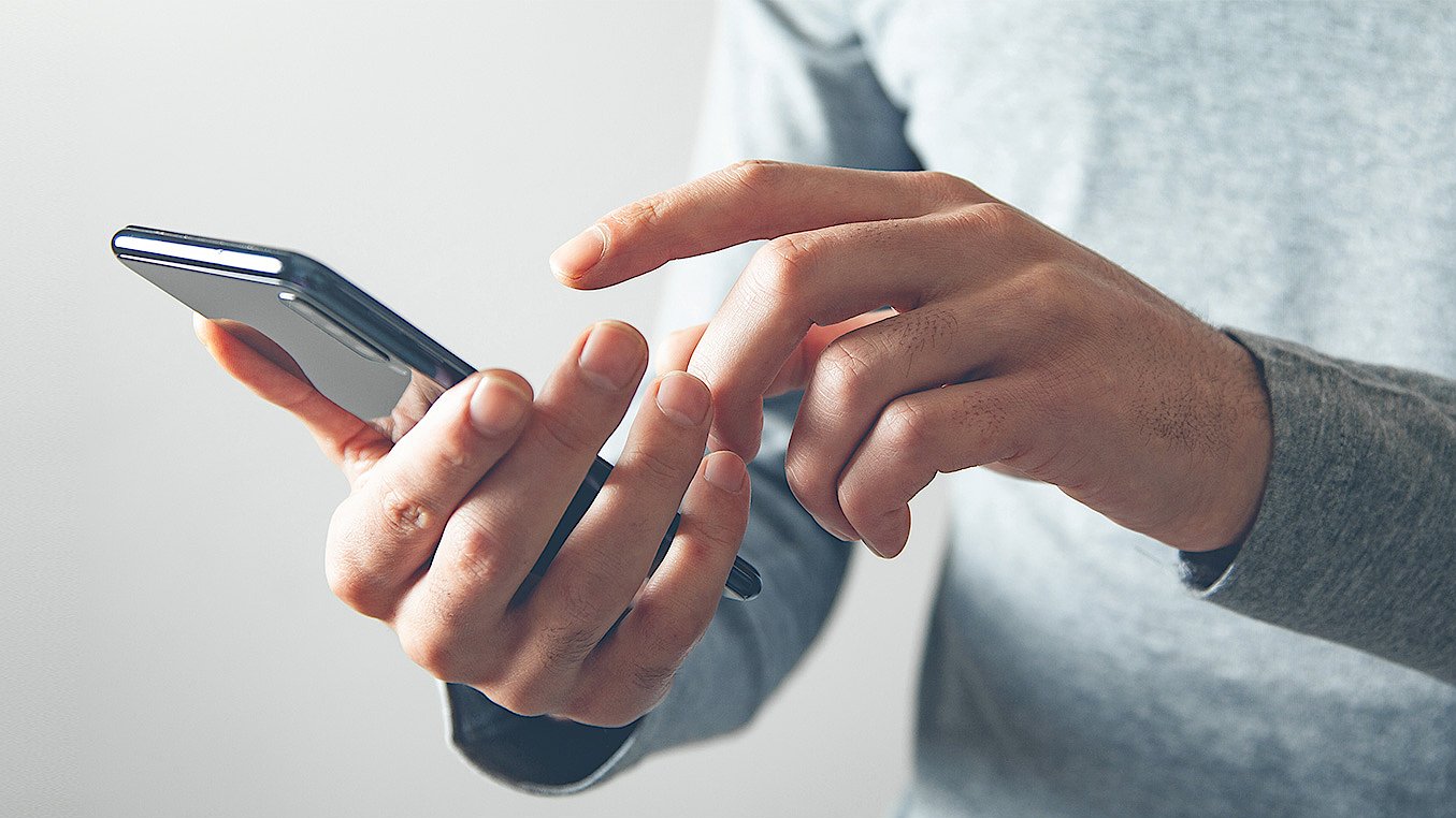 Man typing on smartphone