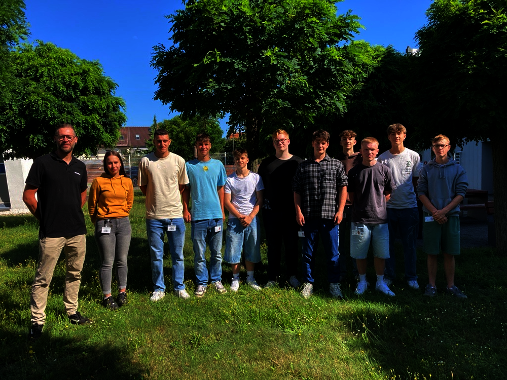 Group photo of the new apprentices with their vocational trainer